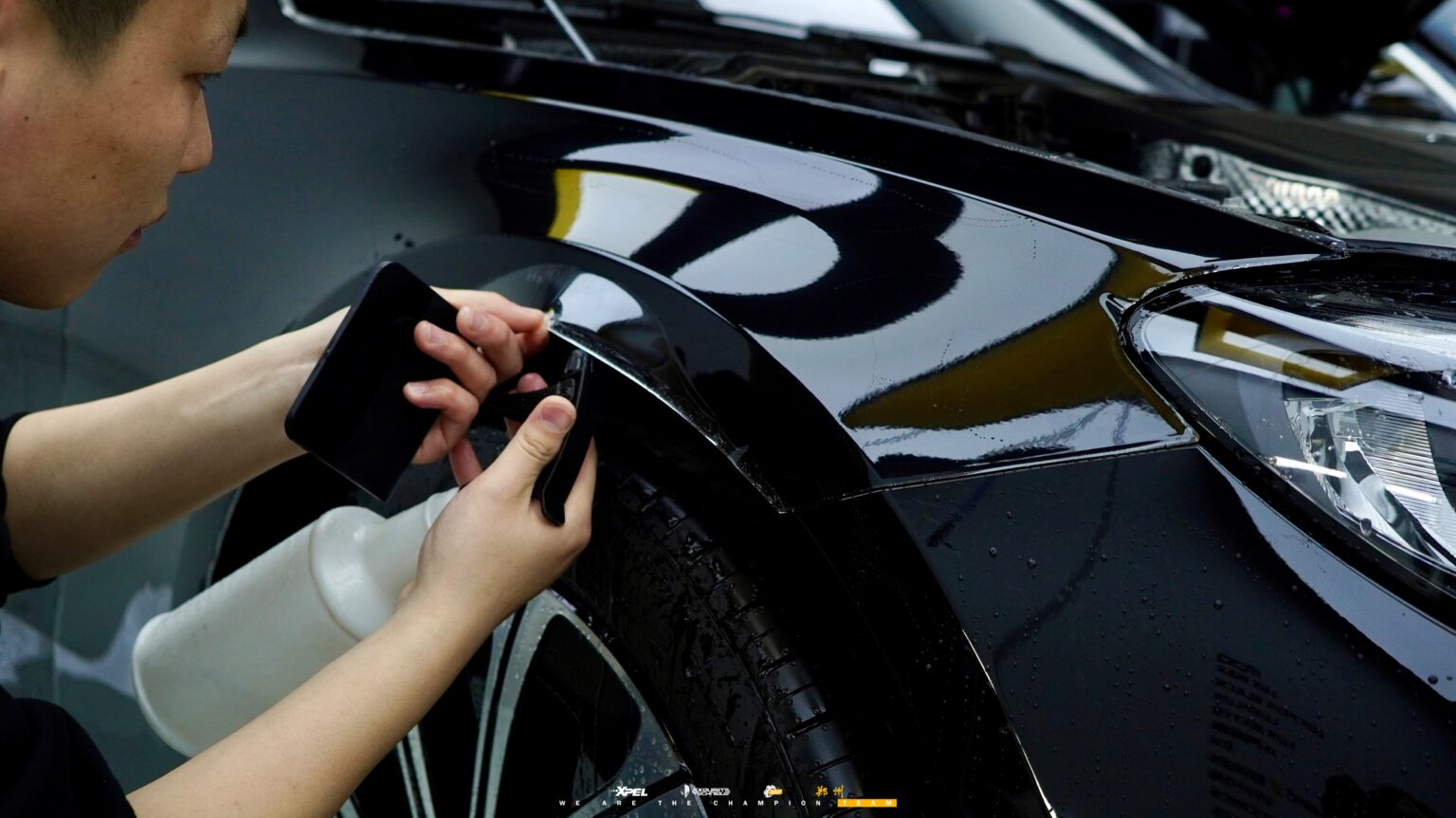 技师在奔驰 E300 车顶与天窗边缘贴合膜体